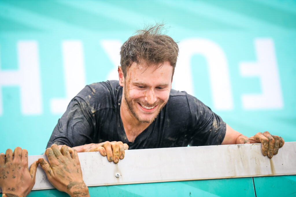man on tough mudder block ness monster obstacle