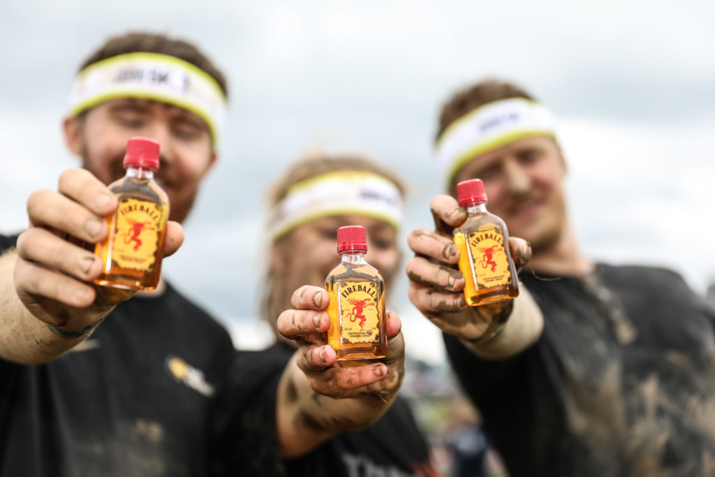 three people holding fireball minis
