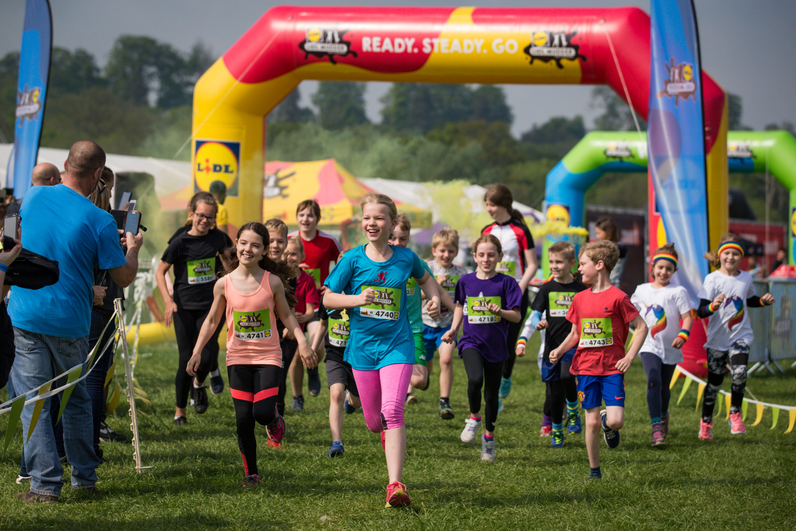 Kid participants running with big smiles on their faces