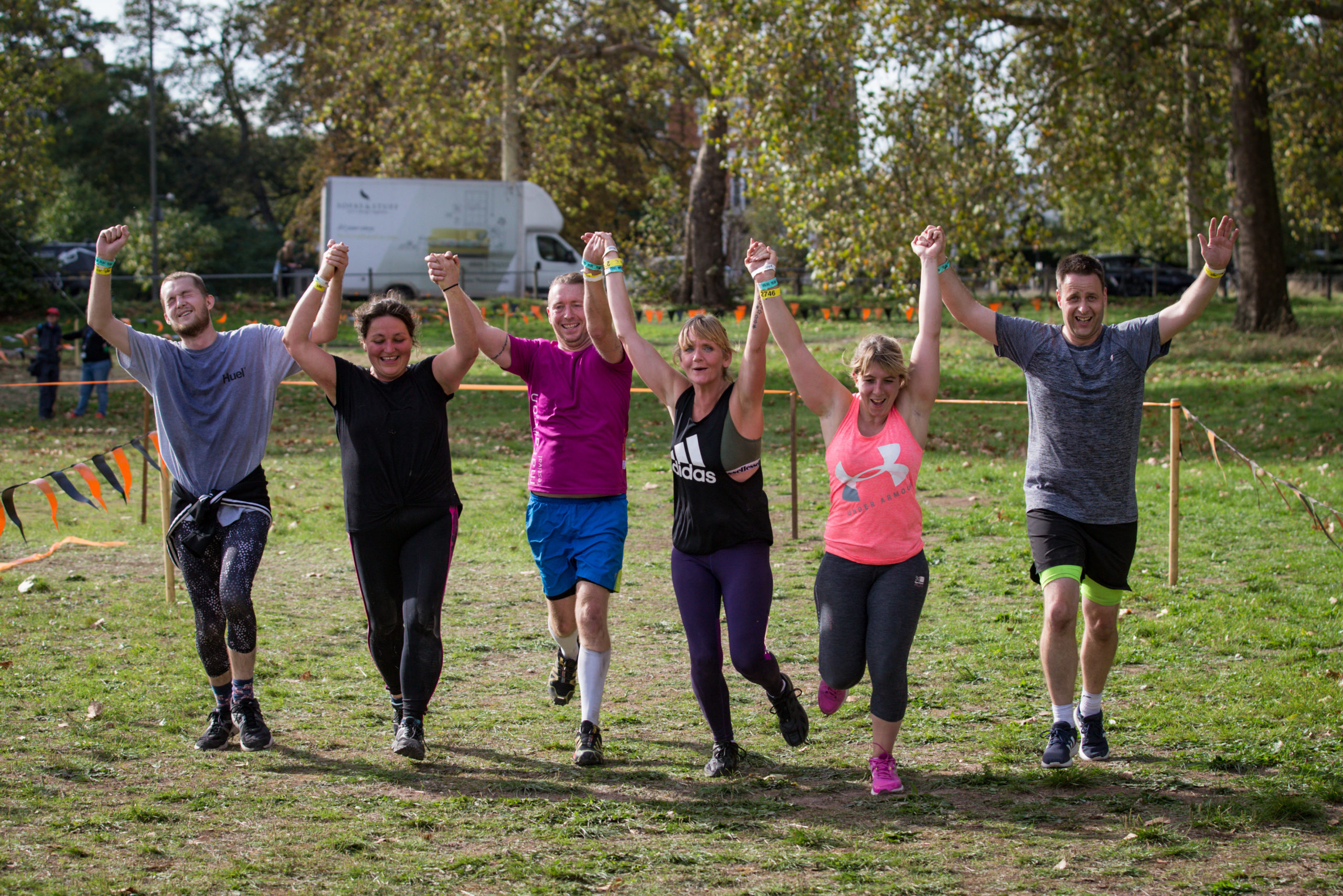People running and holding hands