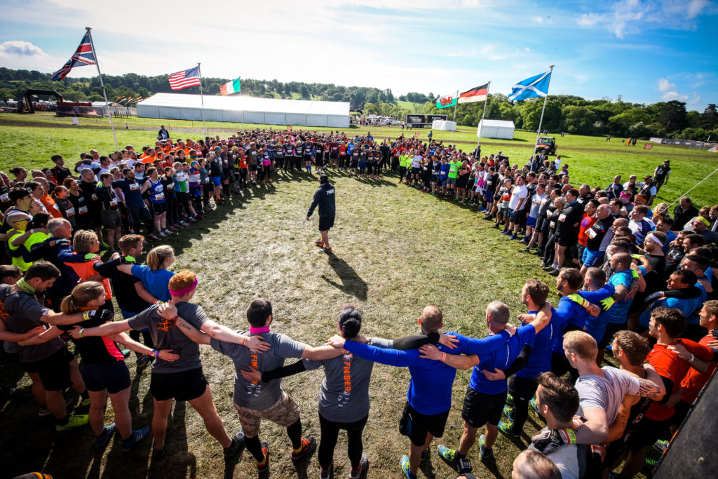 A large group of people stand in a circle.