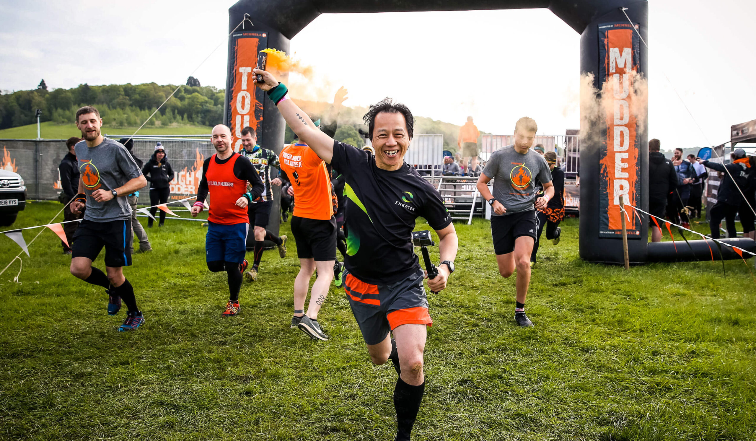 Participant holding a smoke bomb as he ran from the starting line
