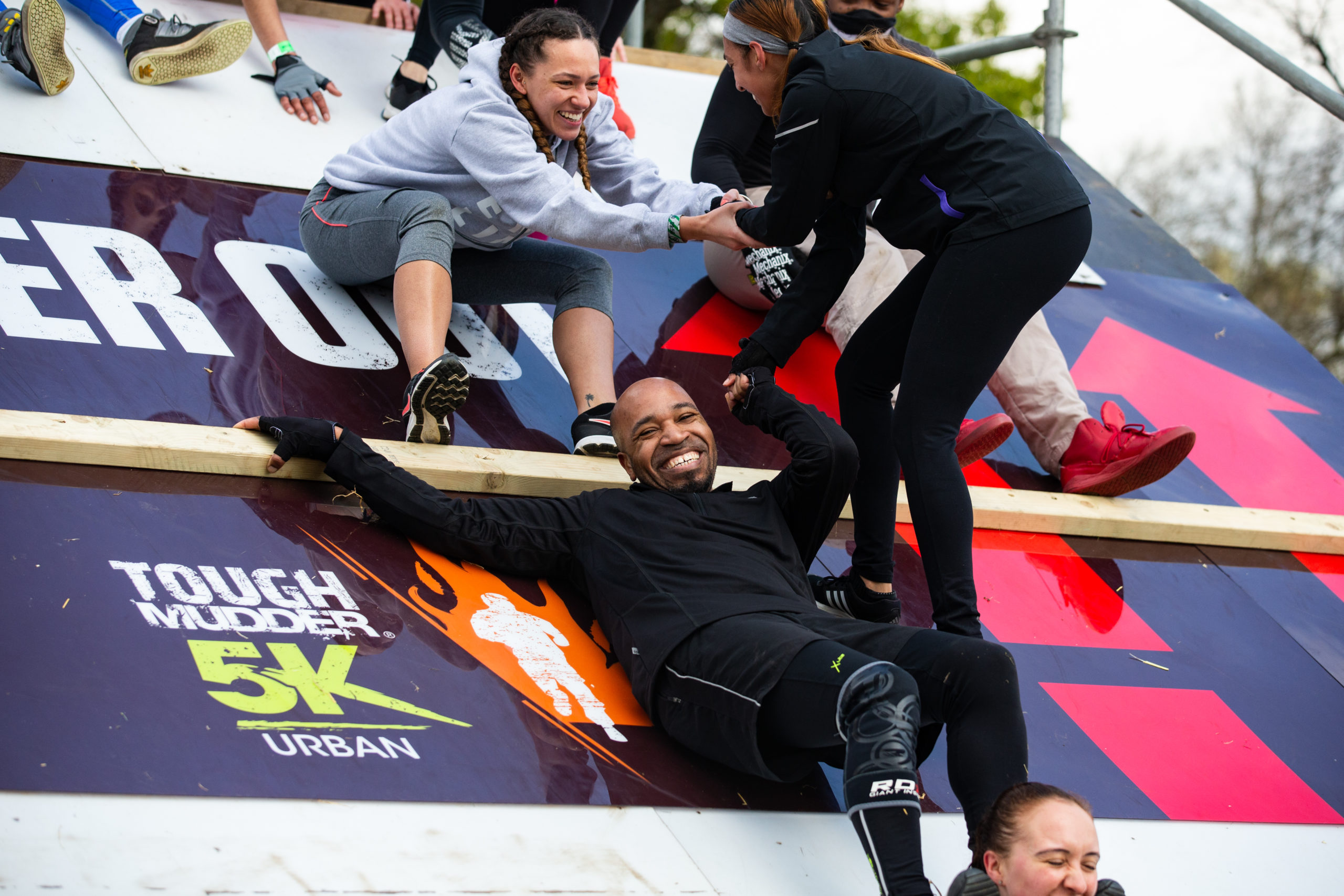 A participant smiling as he slide on the platform