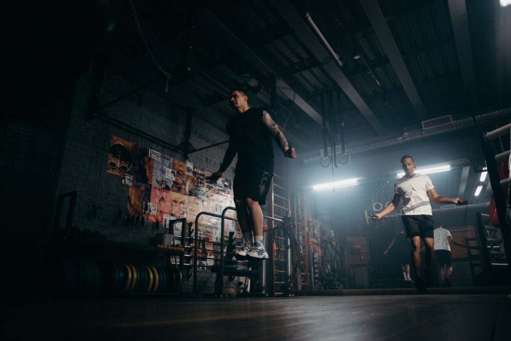two men jump rope in gym