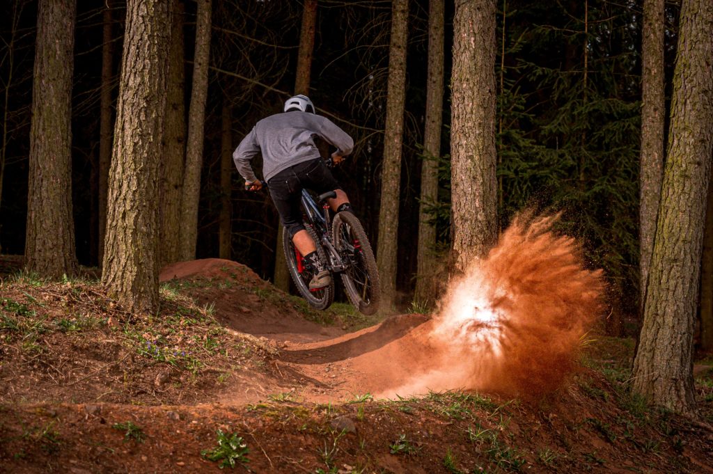 man biking through forest