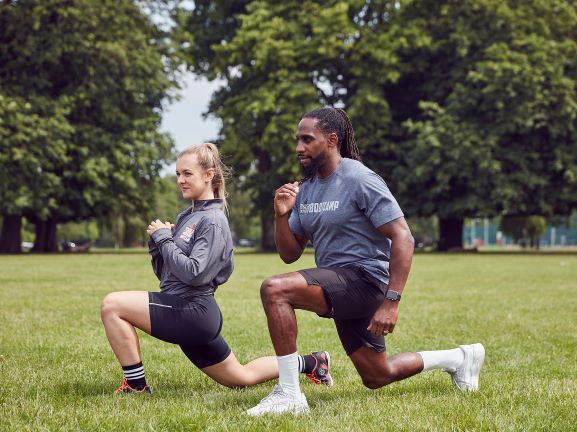 Two participants kneeling with serious faces