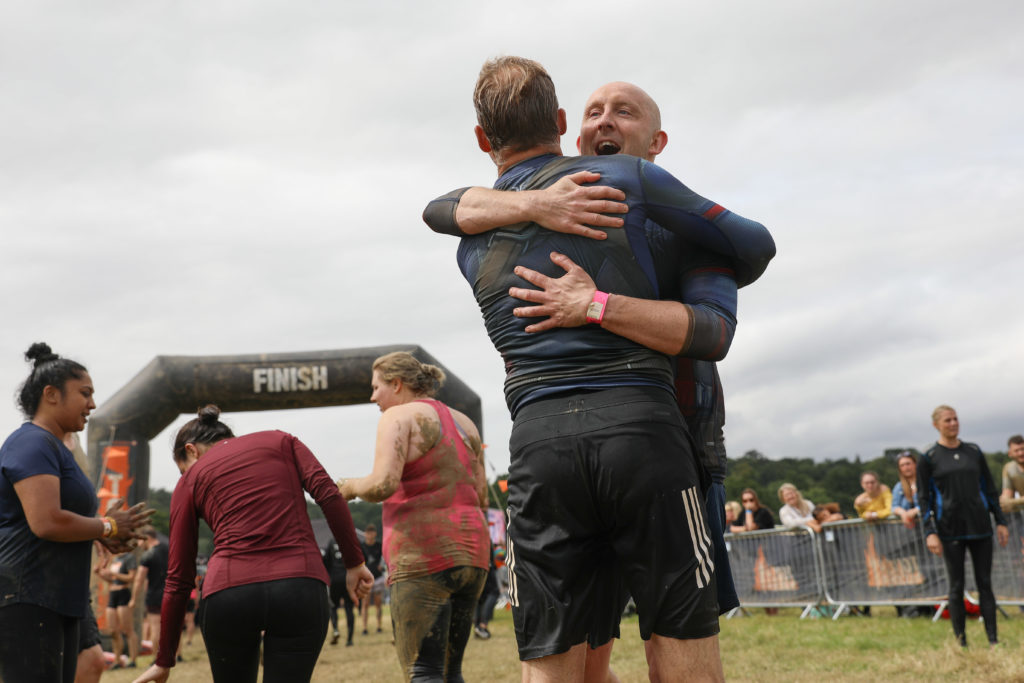 two men hugging at finish