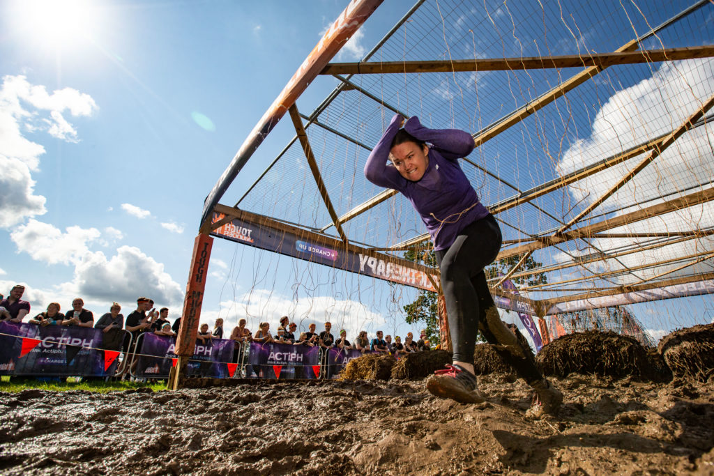 man cover head and running in mud