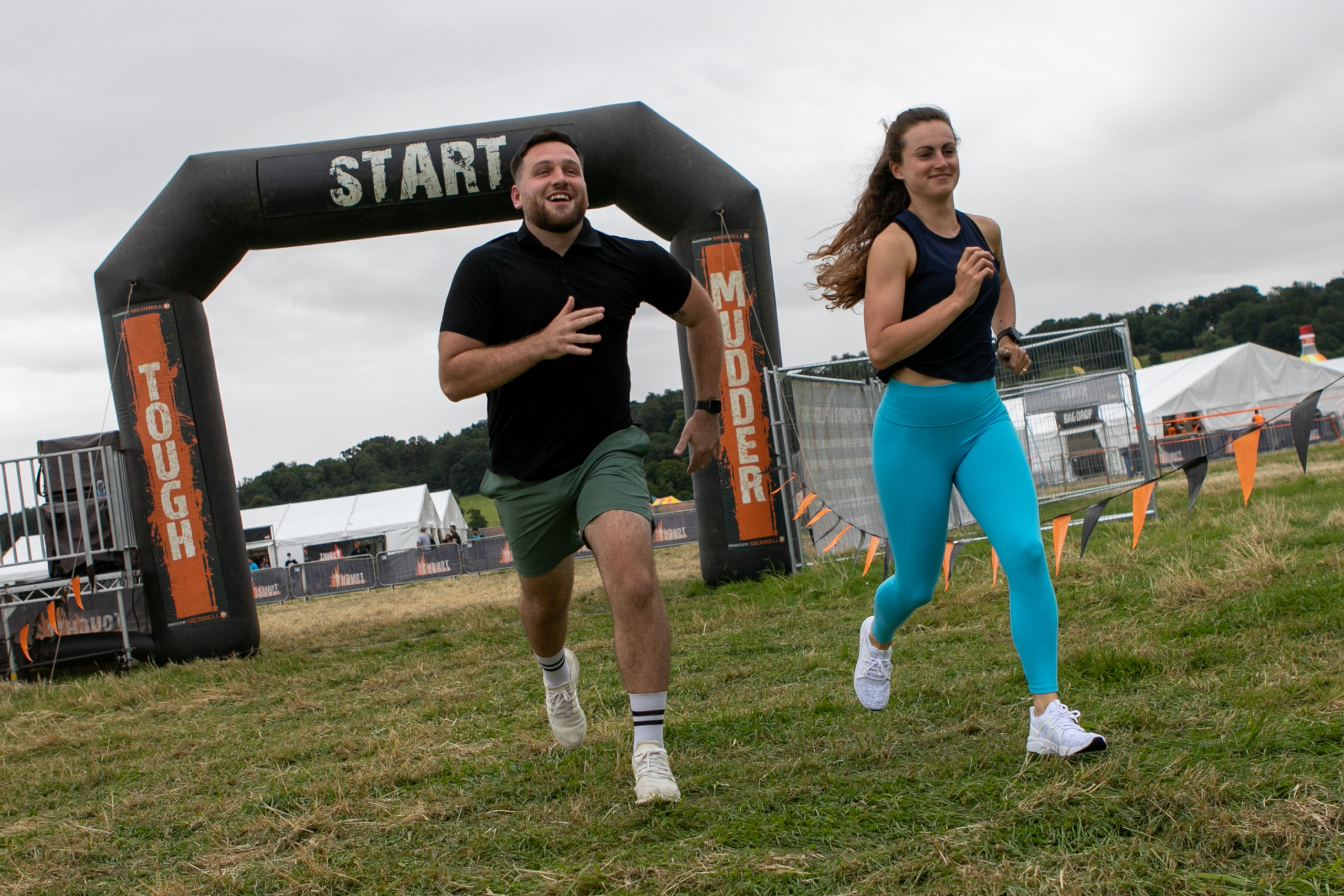 Two participants running from the starting line