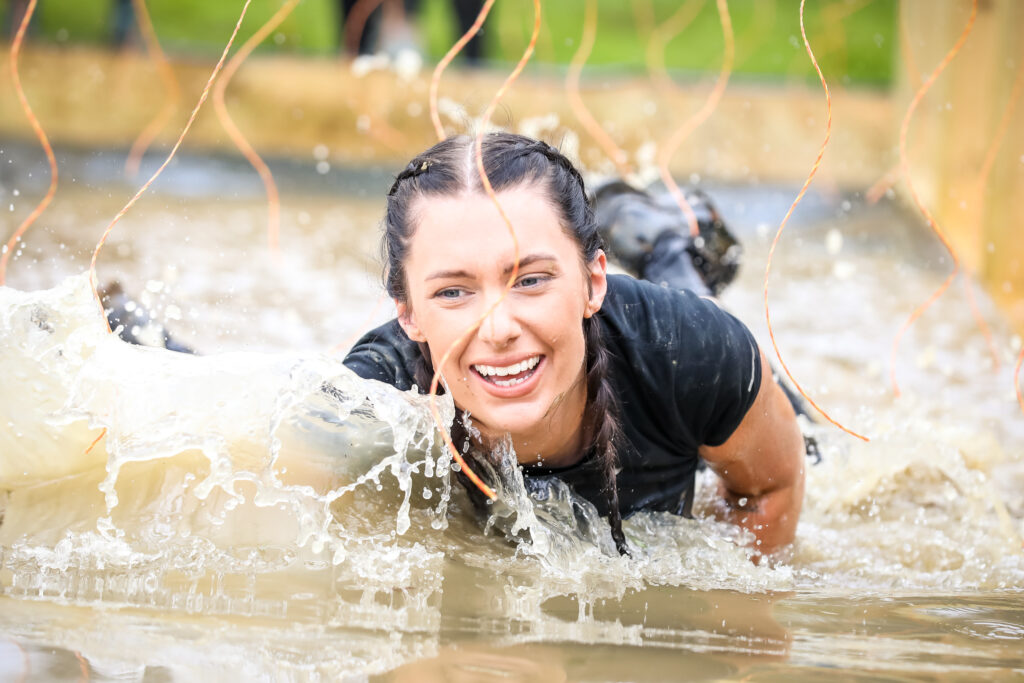 girl in water obstacle outside in summer