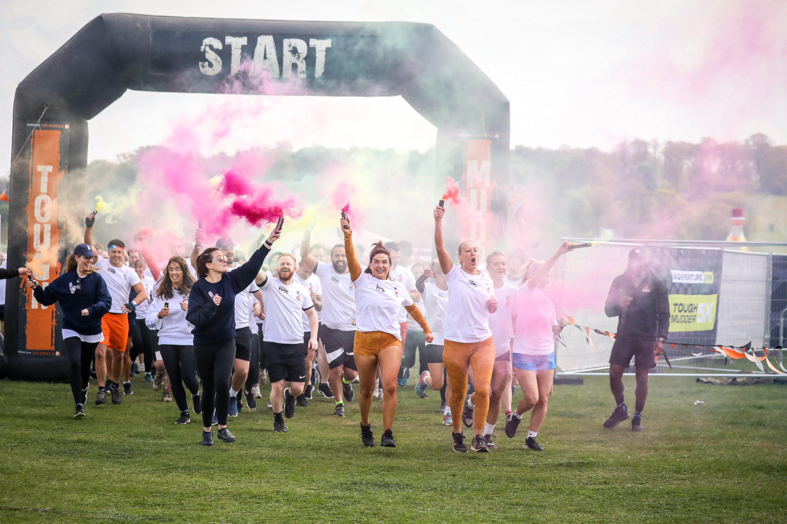 runners with flares three fold takes on Tough Mudder