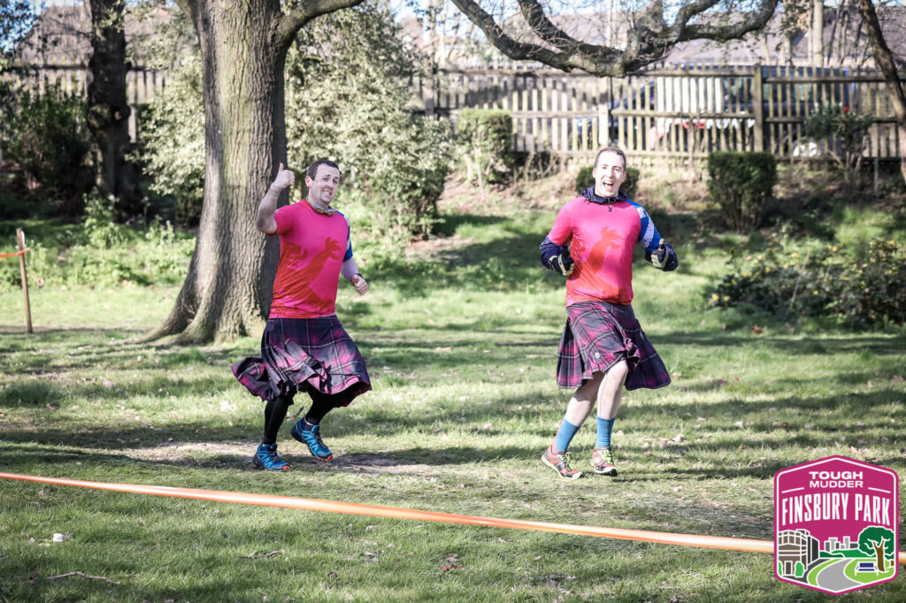 two men in kilts running event highlight