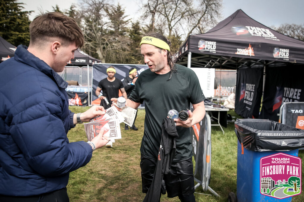 man getting partner freebies at Tough Mudder