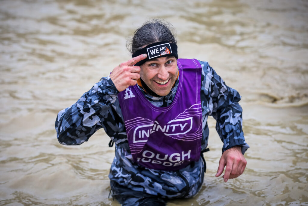 man in water pointing at infinity headband 