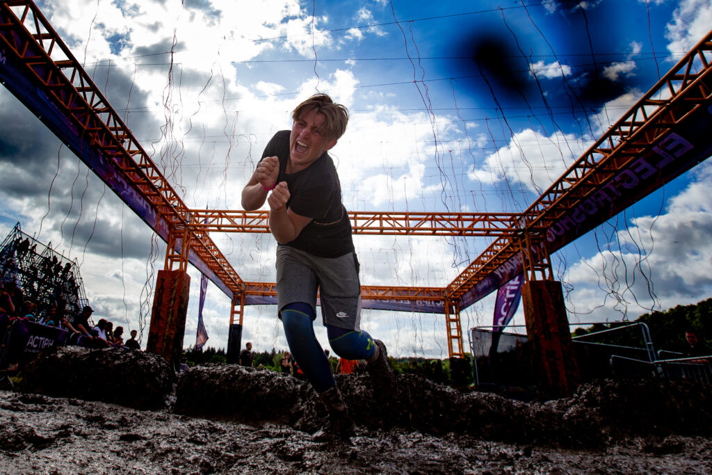 boy running through tough Mudder electroshock obstacle