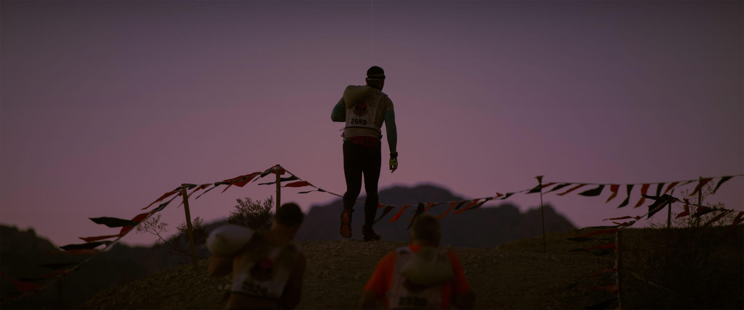 Tough Mudder Endurance participant running at dusk.