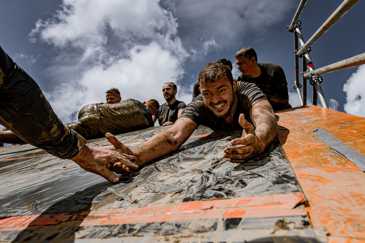 Participant smiling as he reach the hand of another participant