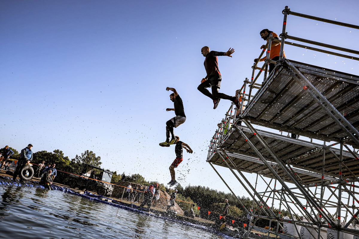 Participants jumping to the mud water
