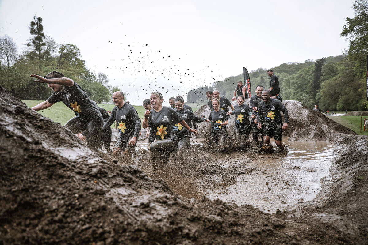Participants walking in the mud