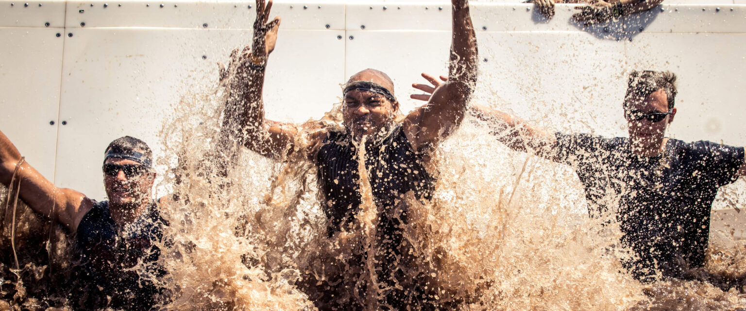 Participants smiling as they slid on the platform