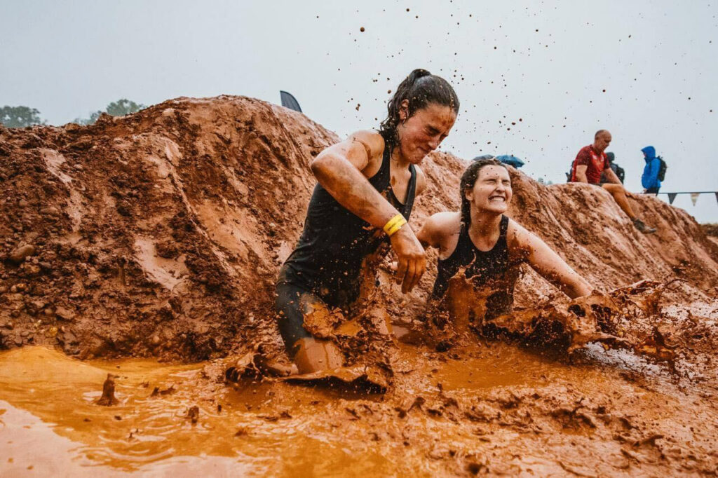 Participants jump to the mud