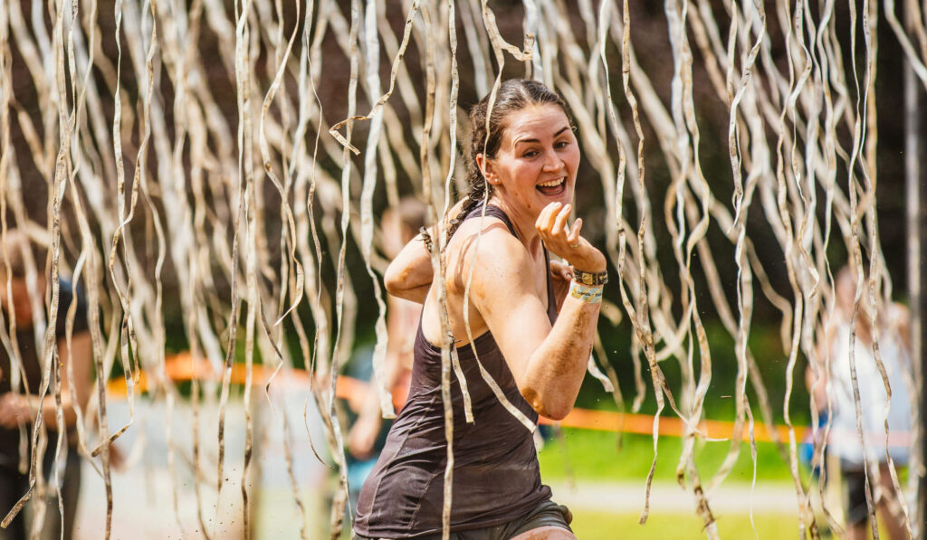 A participant smiling while running through the Electroshock Therapy